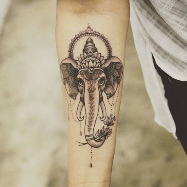 For yogis who prefer a simple black ink tattoo design, opt for this elephant-hea...