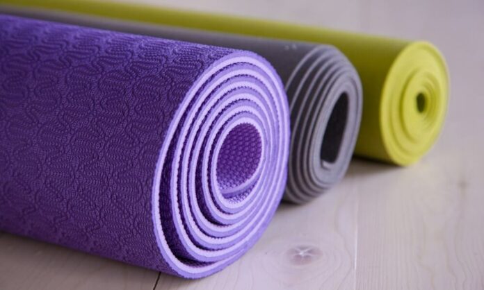How do I keep my yoga mat from slipping on carpet?