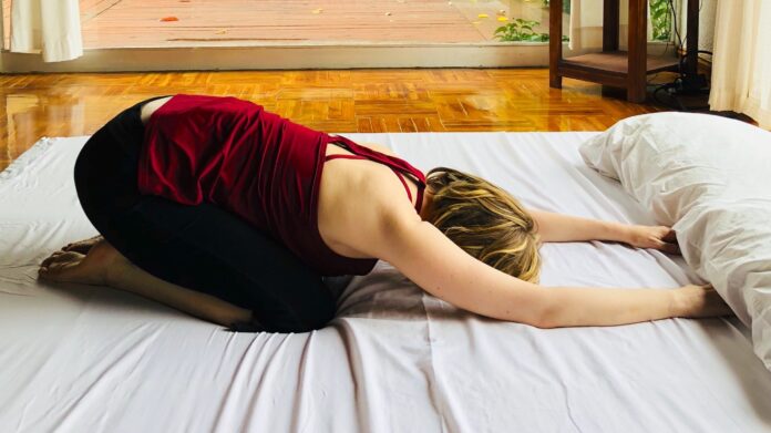 How do you do yoga on a bed?